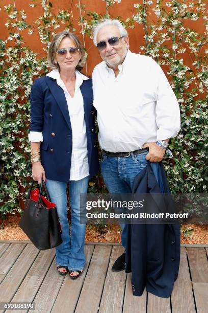 Dominique Strauss-Kahn and his companion Myriam L'Aouffir attend the 2017 French Tennis Open - Day Three at Roland Garros on May 30, 2017 in Paris,...