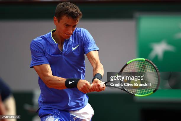 Andrey Kuznetsov of Russia hits a backhand during the first round match against Andy Murray of Great Britain on day three of the 2017 French Open at...