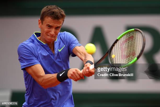 Andrey Kuznetsov of Russia hits a backhand during the first round match against Andy Murray of Great Britain on day three of the 2017 French Open at...