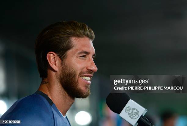 Real Madrid's defender Sergio Ramos attends an interview in the mixed zone at Valdebebas Sport City in Madrid on May 30, 2017 at the Media Day event...