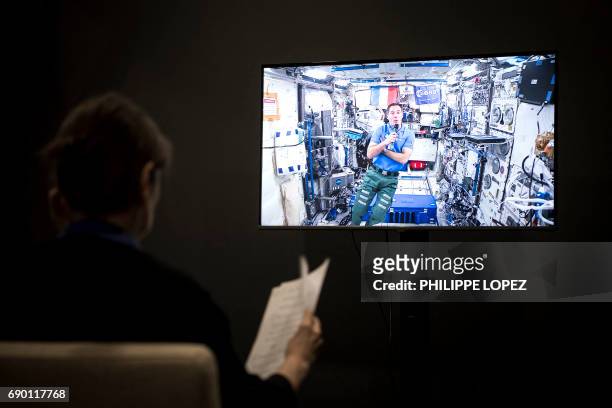 This picture taken on May 30 shows French astronaut Thomas Pesquet , aboard the International Space Station, giving an interview to an AFP journalist...