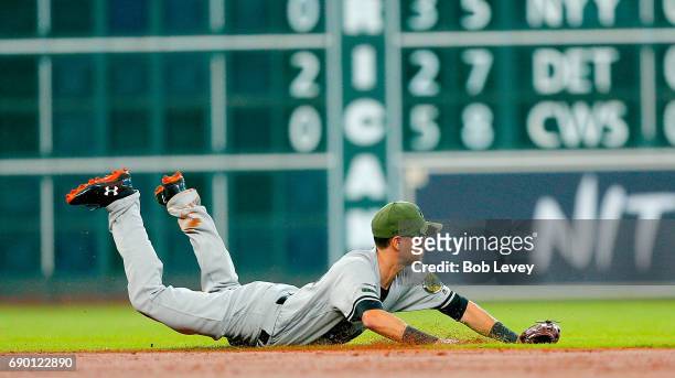 Paul Janish of the Baltimore Orioles dives for a ground ball up the middle against the Houston Astros at Minute Maid Park on May 28, 2017 in Houston,...