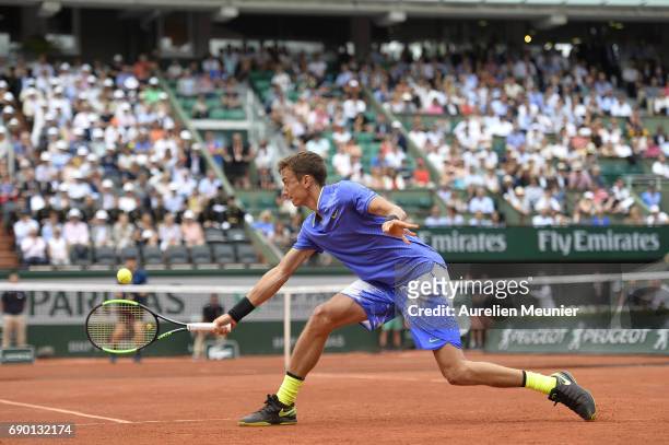 Andrey Kuznetsov of Russia plays a backhand during his men's single match against Andy Murray of Great Britain on day three of the 2017 French Open...