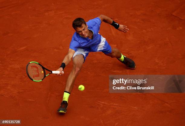 Andrey Kuznetsov of Russia reaches for a forehand during the first round match against Andy Murray of Great Britain on day three of the 2017 French...