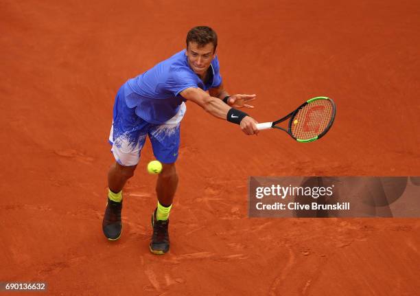 Andrey Kuznetsov of Russia reaches for a backhand during the first round match against Andy Murray of Great Britain on day three of the 2017 French...