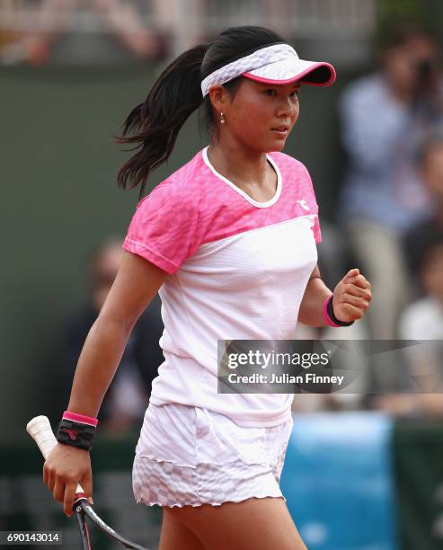 Risa Ozaki of Japan celebrates during the ladies singles first round match against Eugenie Bouchard of Canada on day three of the 2017 French Open at...