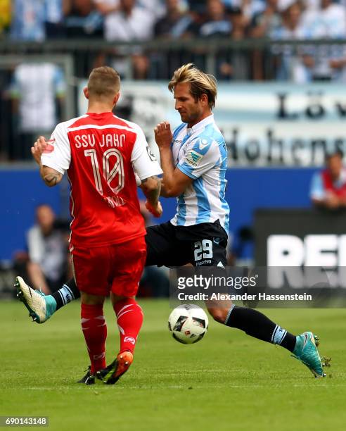 Stefan Aigner of 1860 Muenchen and Marvin Knoll of Jahn Regensburg compete for the ball during the Second Bundesliga Playoff second leg match...