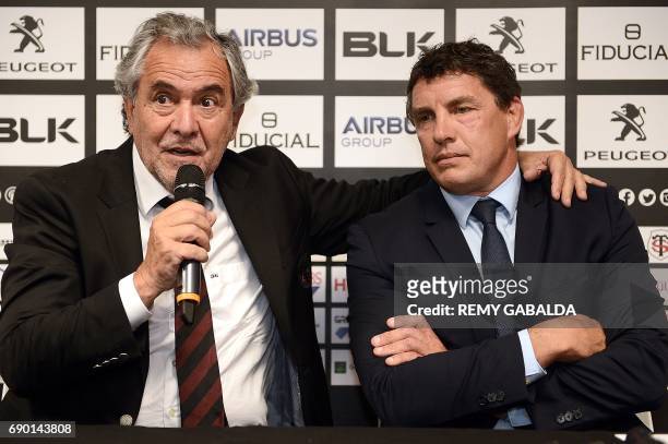 Stade Toulousain Rugby club president Jean Rene Bouscatel , flanked by former Toulouse player Didier Lacroix, speaks during a press conference...