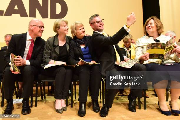 Scottish Culture Secretary Fiona Hyslop watches as fellow Scottish Government ministers pose for a selfie at the launch of the SNP general election...