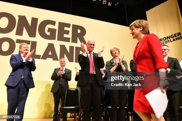 Leader Nicola Sturgeon is applauded by Depute Leader Angus Robertson and Scottish Government ministers as she takes the stage at the launch of the...