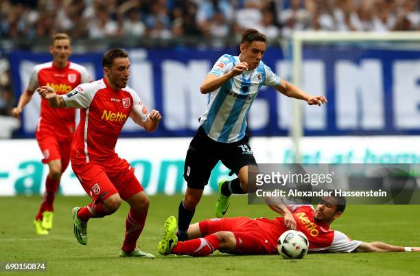 Florian Neuhaus of 1860 Muenchen and Andreas Geipl and Marco Gruettner of Jahn Regensburg compete for the ball during the Second Bundesliga Playoff...