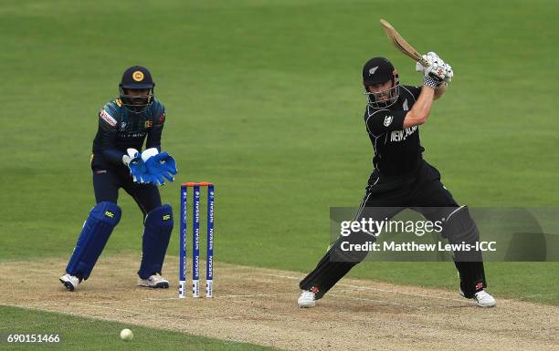 Kane Williamson of New Zealand edges the ball towards the boundary, as Niroshan Dickwella of Sri Lanka looks on during the ICC Champions Trophy...