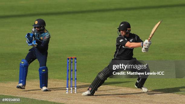 Neil Broom of New Zealand hits the ball towards the boundary, as Niroshan Dickwella of Sri Lanka looks on during the ICC Champions Trophy Warm-up...
