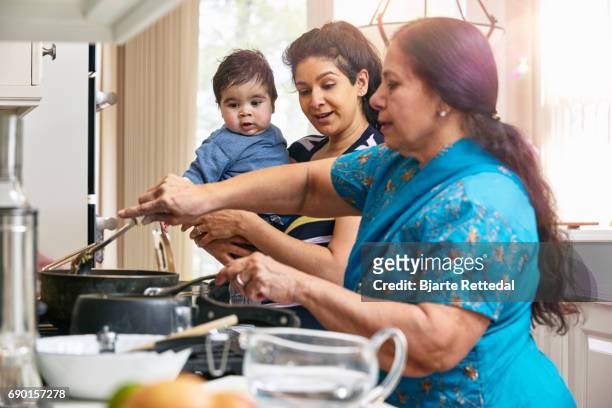 indian american family cooking - 3 women senior kitchen stock pictures, royalty-free photos & images
