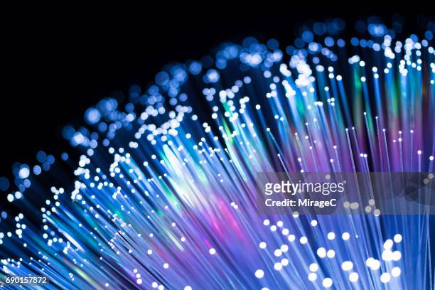 blue fiber optics with spectrum - fiber optics stock-fotos und bilder