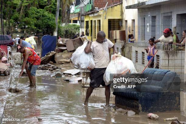 Residents of the city of Barreiros try to save their belongings form their homes affectd by floods, due to heavy rains in Pernambuco state,...