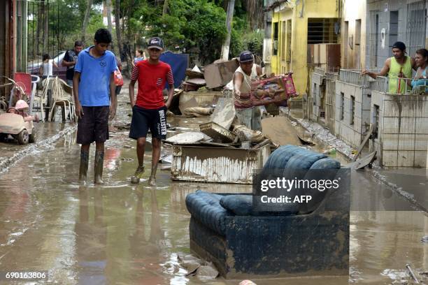 Residents of the city of Barreiros try to save their belongings form their homes affectd by floods, due to heavy rains in Pernambuco state,...