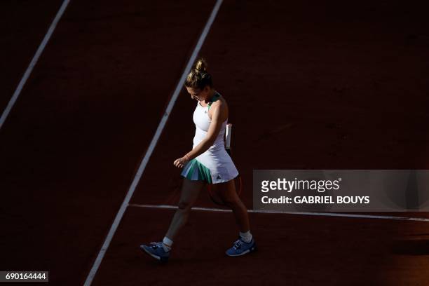 Romania's Simona Halep walks on the court as she plays against Slovakia's Jana Cepelova during their tennis match at the Roland Garros 2017 French...