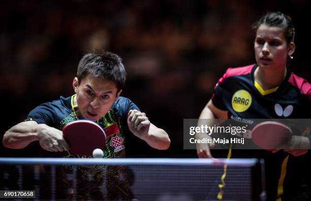 Fang Bo of China and Petrissa Solja of Germany compete during mixed double 1. Round at Table Tennis World Championship at Messe Duesseldorf on May...