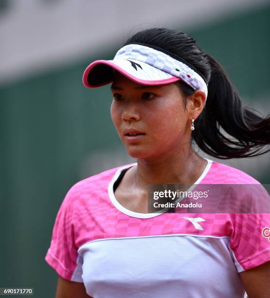 Risa Ozaki of Japan returns to Eugenie Bouchard of Canada during their first round match of the French Open tennis tournament at the Roland Garros...