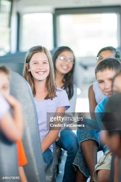 spaß auf dem weg zur schule - kids sitting together in bus stock-fotos und bilder