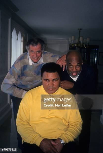 Portrait of former heavyweight champion Muhammad Ali with his friend, photographer Howard Bingham and Sports Illustrated writer Frank Deford during...