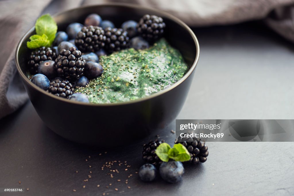 Healthy organic spirulina porridge topped with berries