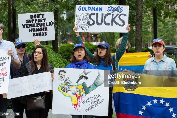 Demonstrators hold signs and chant during a protest outside of the Goldman Sachs Group Inc. Headquarters in New York, U.S., on Tuesday, May 30, 2017....