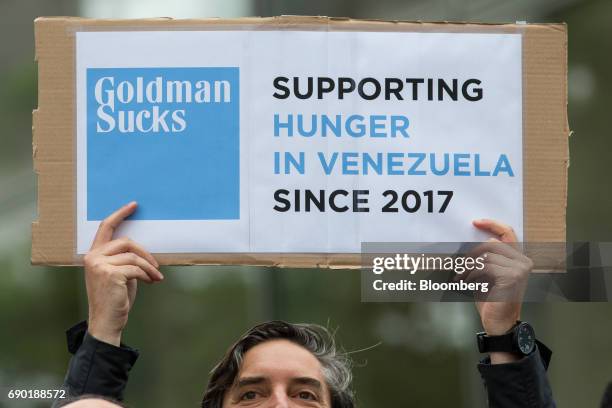 Demonstrator holds a sign during a protest outside of the Goldman Sachs Group Inc. Headquarters in New York, U.S., on Tuesday, May 30, 2017. Goldman...