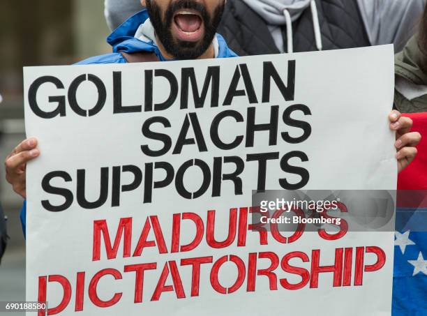 Demonstrator holds a sign and chants during a protest outside of the Goldman Sachs Group Inc. Headquarters in New York, U.S., on Tuesday, May 30,...