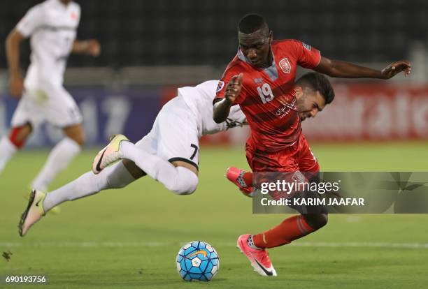 Iran's Persepolis FC midfielder Mohsen Mosalman and Qatar's Lekhwiya forward Ali al-Moez vie for the ball during the AFC Champions League football...