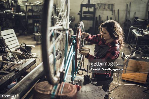 repairing her bike - bicycle tire stock pictures, royalty-free photos & images