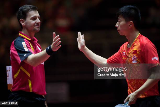 Ma Long of China and Timo Boll of Germany celebrate after Men Double 1. Round at Table Tennis World Championship at Messe Duesseldorf on May 30, 2017...