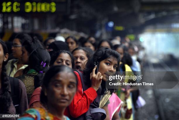 Young commuter eagerly waiting for the trains to come at Dadar Station. Motormen of Western Railway went on a flash strike as their colleague got...