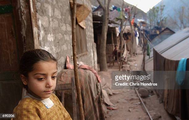 Kashmir refugee stands in a narrow alley of a refugee camp near Muzaffer Abad, the Line of Control between India and Pakistan, January 5, 2002 in...