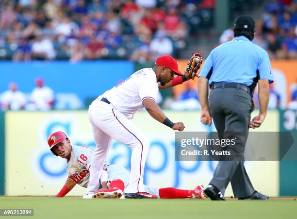 Elvis Andrus of the Texas Rangers looks on as Phil Cuzzi calls Cesar Hernandez of the Philadelphia Phillies out on second base in the first inning at...