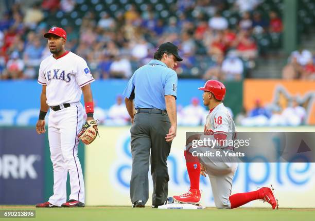 Elvis Andrus of the Texas Rangers looks on as Phil Cuzzi calls Cesar Hernandez of the Philadelphia Phillies out on second base in the first inning at...