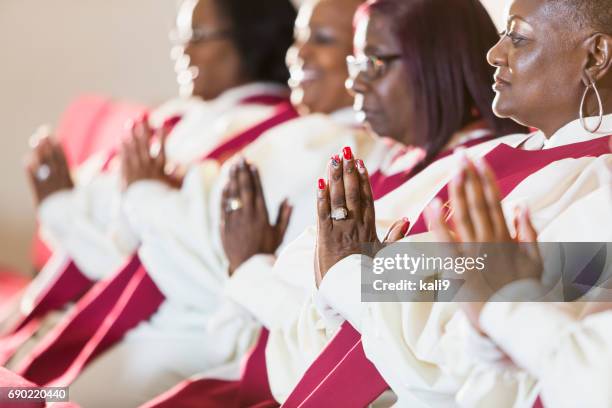 group of mature black women in church robes - gospel choir stock pictures, royalty-free photos & images