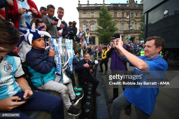 Dean Hoyle chairman / owner of Huddersfield Town takes photos of fans with the Sky Bet Championship Play off trophy on May 30, 2017 in Huddersfield,...