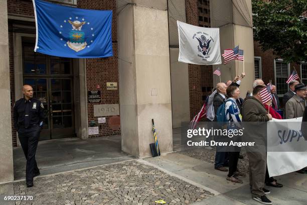 Law enforcement officer exits the building as supporters of Joe Concannon, a retired NYPD captain and current candidate for NYC City Council District...