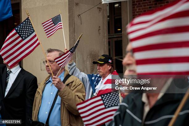 Supporters of Joe Concannon, a retired NYPD captain and current candidate for NYC City Council District 23, wave American flags during a 'Support...