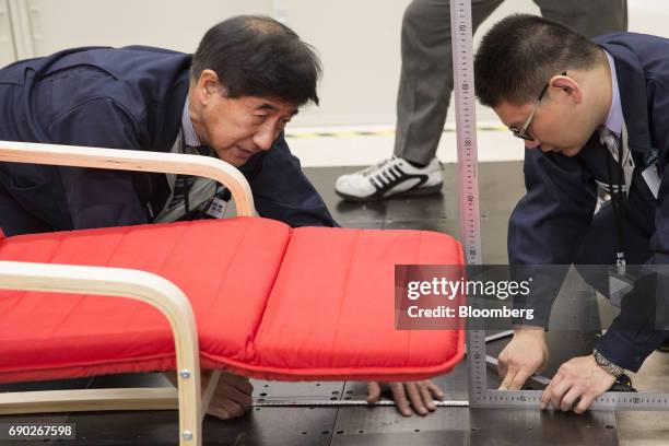 Members of a Nitori Holdings Co. Quality control team measure a chair during a product test in Tokyo, Japan, on Tuesday, April 25, 2017. In the 12...