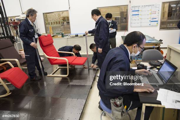 Members of a Nitori Holdings Co. Quality control team measure a chair during a product test in Tokyo, Japan, on Tuesday, April 25, 2017. In the 12...