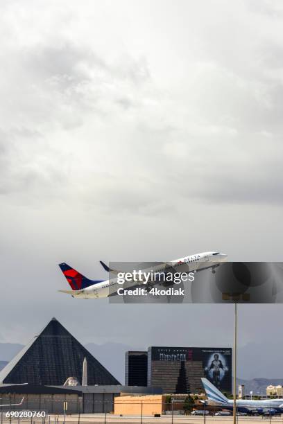 las vegas hotel casino buildings with airplane taking off in the foreground - aeromexico stock pictures, royalty-free photos & images