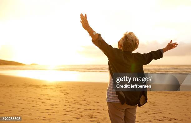 embrace life with open arms - elderly woman from behind stock pictures, royalty-free photos & images