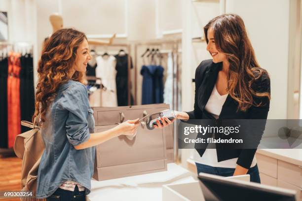 contactless payment - clothes shop counter stock pictures, royalty-free photos & images