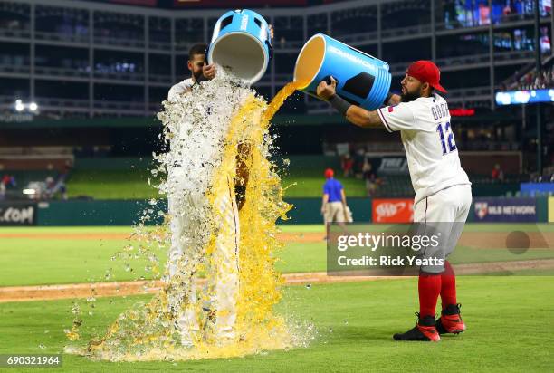 Rougned Odor of the Texas Rangers and Nomar Mazara dump the cooler on Elvis Andrus at the conclusion of the game against the Tampa Bay Rays at Globe...