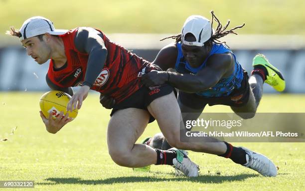 Ben McNiece of the Bombers is tackled by teammate Anthony McDonald-Tipungwuti during an Essendon Bombers AFL media session at True Value Solar Centre...