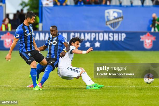 Montreal Impact defender Ambroise Oyongo in collision with Vancouver Whitecaps player during the Montreal Impact versus the Vancouver Whitecaps FC...