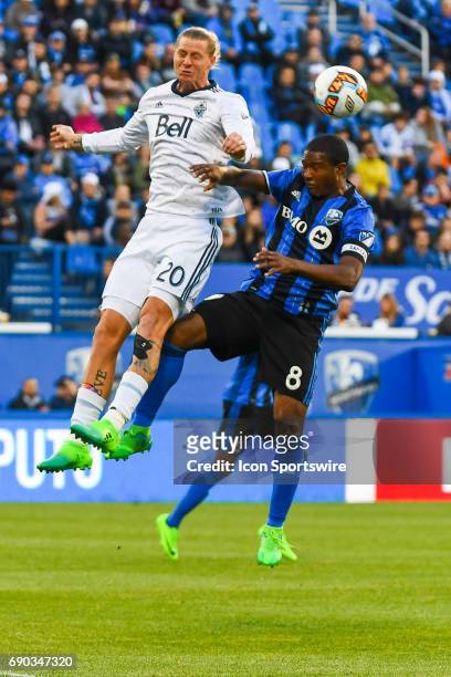 Montreal Impact midfielder Patrice Bernier and Vancouver Whitecaps midfielder Brek Shea jumping in the air to get the ball during the Montreal Impact...